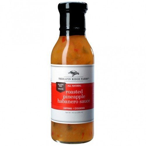 A bottle of Roasted Pineapple Habanero Sauce has a sweet caramelized roasted pineapple taste combined with veggies and fiery habaneros. Perfect for grilling & dipping. The sauce is Gluten Free, & Vegan. Available at Spoonabilities.com