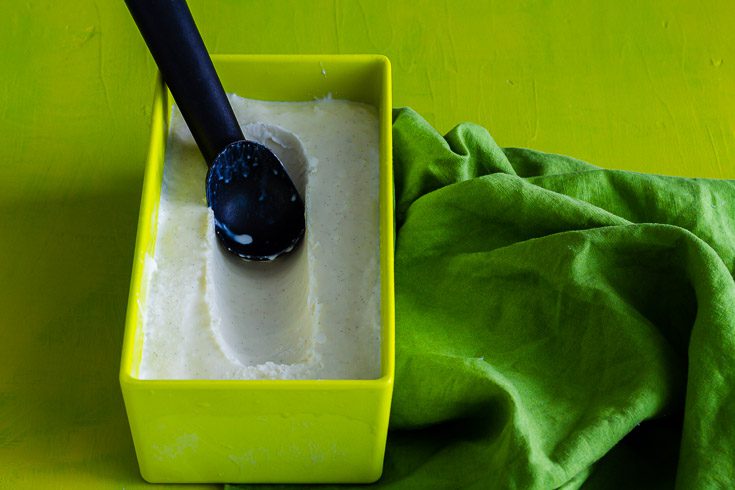 Easy Vanilla Homemade Ice Cream in yellow-green container