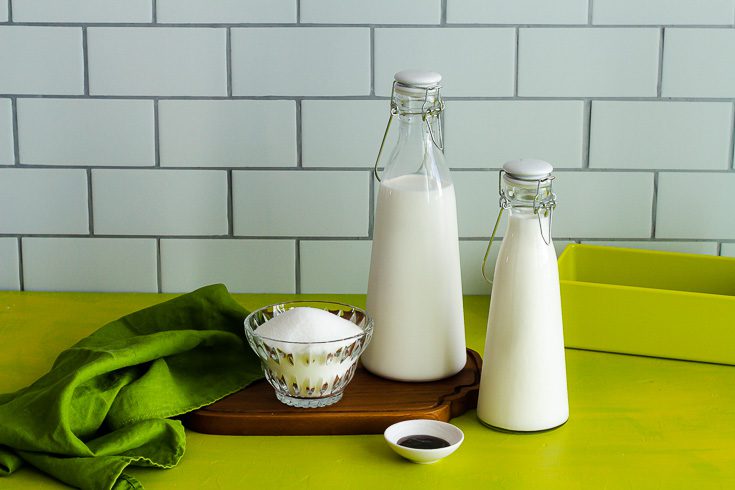 Milk bottles of heavy cream, half-and-half, white sugar and vanilla