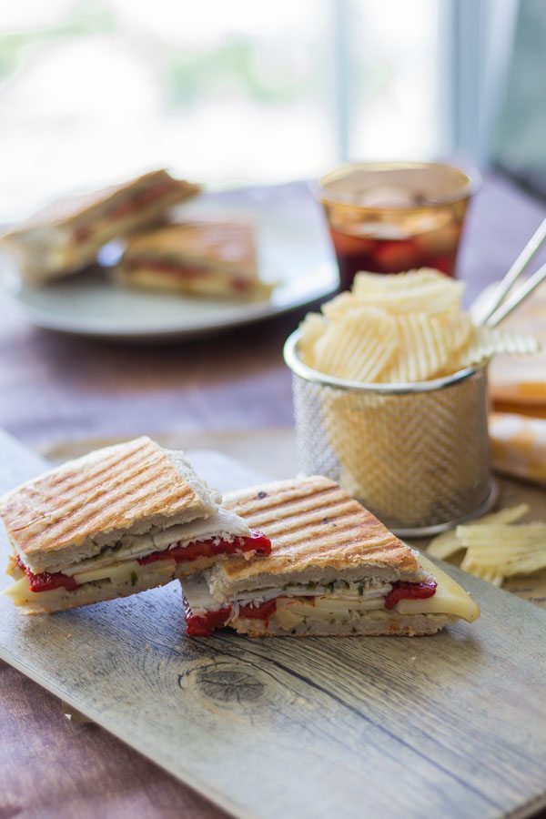 Smoked Turkey Artichoke Panini sandwich was made with Ciabatta sandwich roll, roasted red pepper and smoked Turkey and the Mozzarella cheese. As a spreadable with used the Artichoke Parmesan Tapenade. Find this product and more recipe ideas at Spoonabilities.com