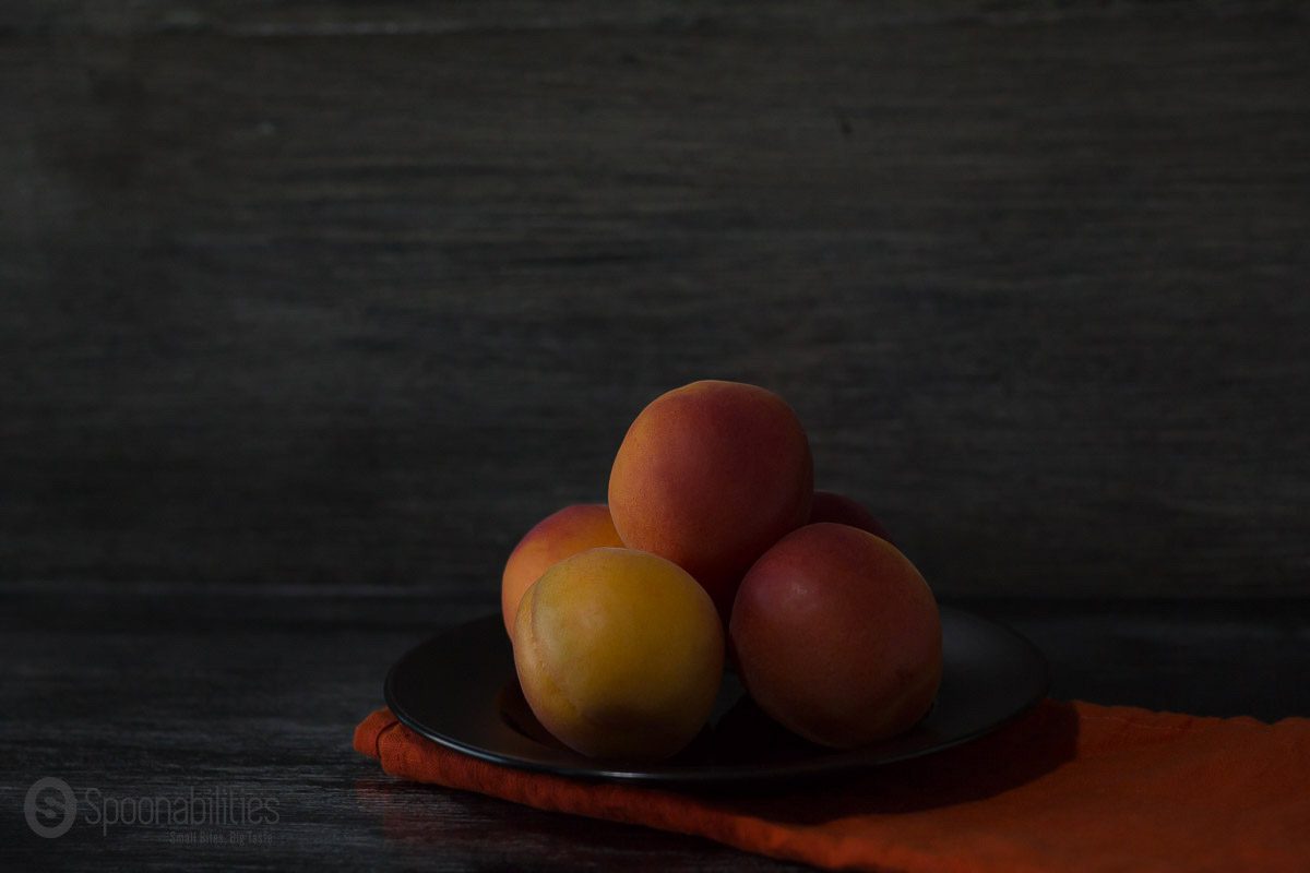 Stone Fruits five Peaches on a plate dark background artistic. Taken by Carlos Leo at Spoonabilities.com