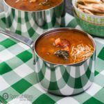 Pot of Hearty Vegetable Soup on a green and white checkered tablecloth