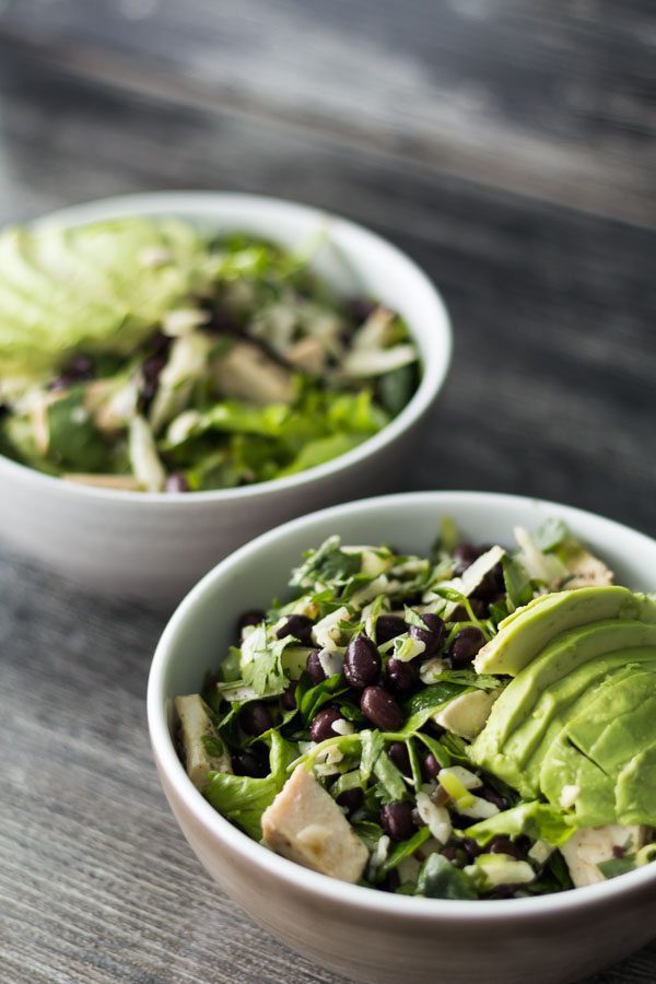 Jalapeño Raspberry Vinaigrette Dressing recipe on Mixed Green Salad with Chicken, Avocado, Black Beans, Cilantro, Green onions & Manchego Cheese. Find this recipe and the Jalapeño Raspberry Jam at Spoonabilities.com