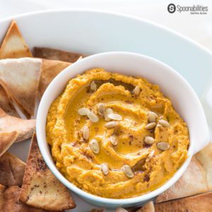 Pumpkin Hummus is the perfect appetizer recipe for Fall holiday parties. Easy to make. Made of chickpeas, Pumpkin Puree, Tahini, Garlic, Parsley & Greek EVOO. Pumpkin hummus is a great appetizer option for your Thanksgiving dinner. Spoonabilities.com