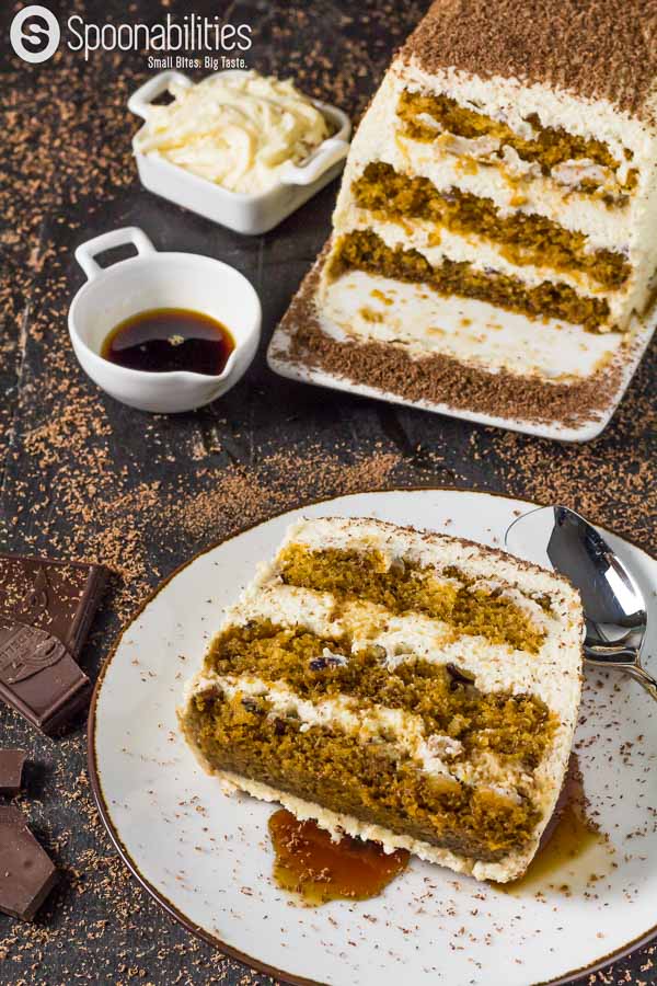 Pumpkin Tiramisu Cake Maple Mascarpone Cream, and containers of coffee syrup and cream in the background.