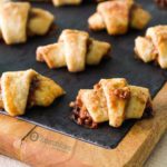 Easy Rugelach cookie with a sweet cream cheese dough is crumbly and filled with a mix of nuts, sugar, cinnamon and with Fig Jam. Available at Spoonabilities.com