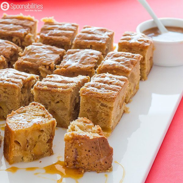 Close up of 12 Caramel Apple Blondies Brownies with a white bowl of caramel sauce by Fat Toad Farm
