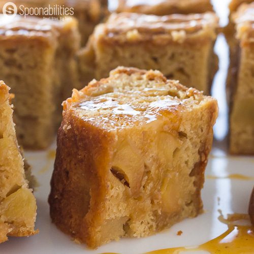 Tight closeup of one Caramel Apple Blondies Brownies simmered in Caramel Sauce available at Spoonabilities.com