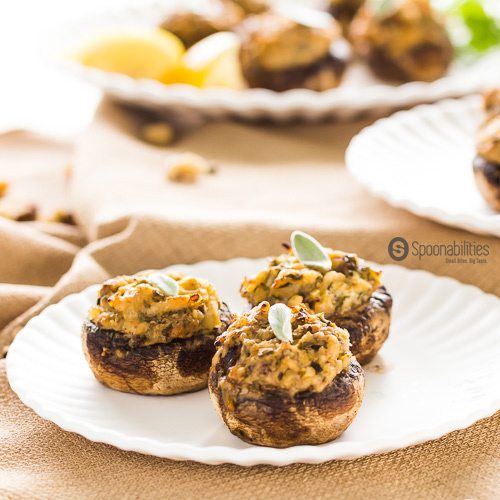 Three Artichoke Pesto Stuffed Mushrooms on a white plate