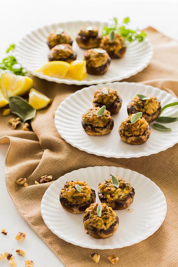 Three plates of Artichoke Pesto Stuffed Mushrooms.