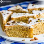 Six slices of Persian Almond Cardamom Pistachio Cake on a round white plate. This cake moist and aromatic dessert recipe. Served for Passover using Kosher ingredients.