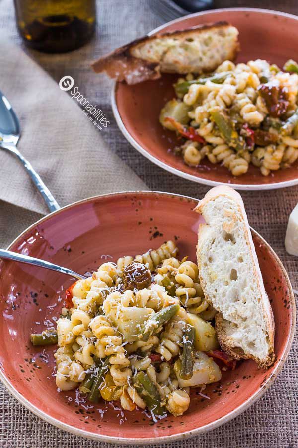 Artichoke Lemon Pesto Pasta Salad is a delicious summer recipe with a lemony tang, rich artichoke taste, and creamy texture. Available at Spoonabilities.com