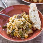 Artichoke Pesto Pasta Salad with with a piece of bread