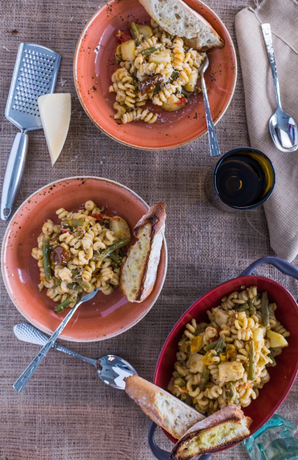 Three bowls of Artichoke Pesto Pasta Salad