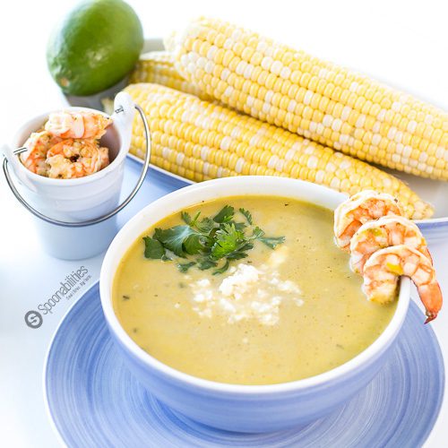 a bowl of comforting mexican food Hatch Green Chile Soup with Cilantro Lime Grilled Shrimp on the side