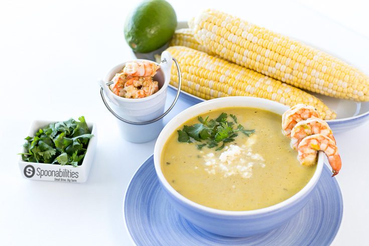 Creamy Hatch Green Chile Soup is a Tex-Mex inspired recipe packed full of flavors from Hatch Chile Pesto, fresh summer corn, coconut milk, and cilantro lime grilled shrimp. 