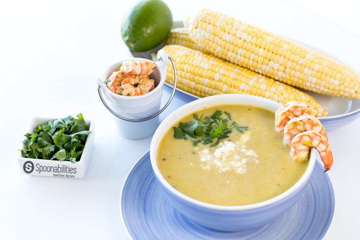 Creamy Hatch Green Chile Soup is a Tex-Mex inspired recipe packed full of flavors from Hatch Chile Pesto, fresh summer corn, coconut milk, and cilantro lime grilled shrimp.