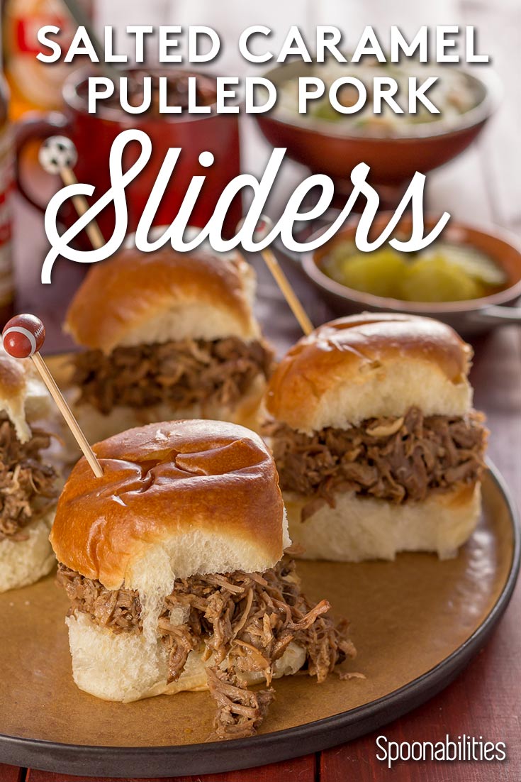 Four Salted Caramel Pulled pork sliders on a plate with condiments in the background. Spoonabilities.com