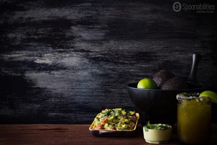 Beautiful background with guacamole, avocados, cilantro and a refreshing margarita. Used for the Pork Carnitas Tacos photo shoot session. Spoonabilities.com