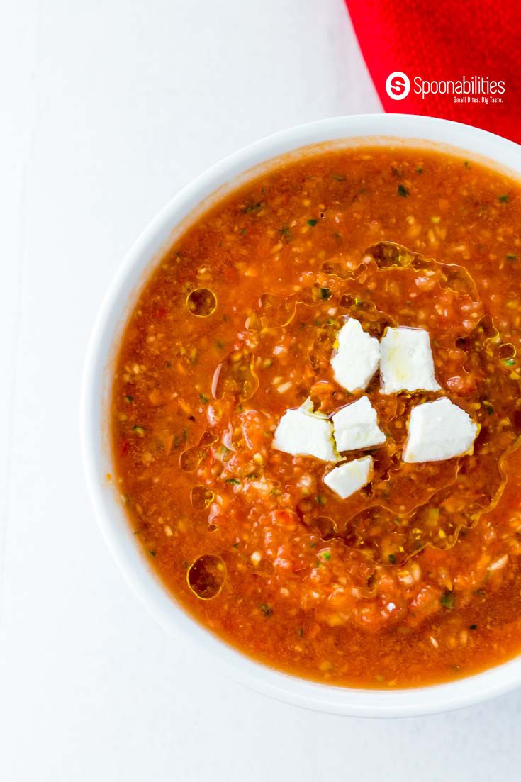 Easy Gazpacho Recipe is a chilled Spanish summer soup that has Roasted Red Pepper Salsa, fresh vegetables, Greek olive oil and small cubes of ricotta Salata cheese. Takes only 10 minutes to make. Spoonabilities.com