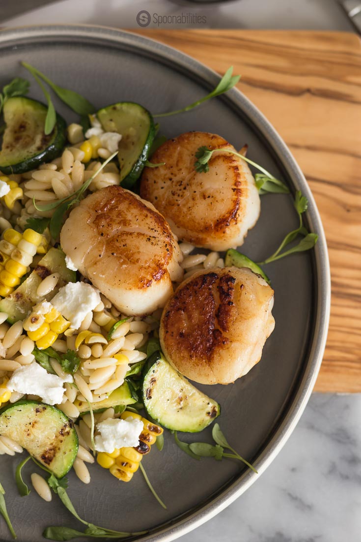 This Grilled Corn Zucchini Orzo Salad has a creamy texture and a tender and crunchy bite. Made with cilantro micro greens. Spoonabilities.com