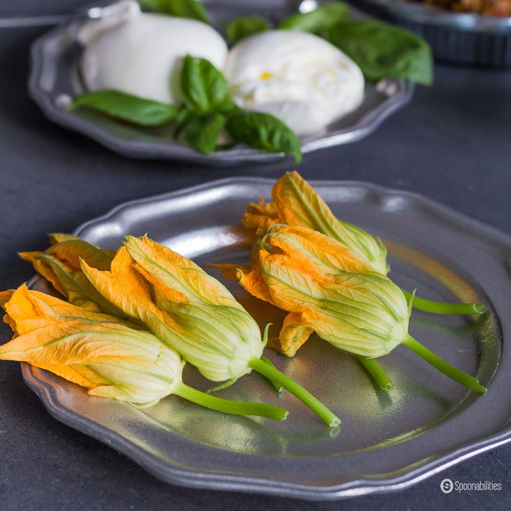 Fresh Stuffed Squash Blossoms in their raw state look beautiful on your table with the vibrant orange-yellow color of these edible flowers. Spoonabilities.com