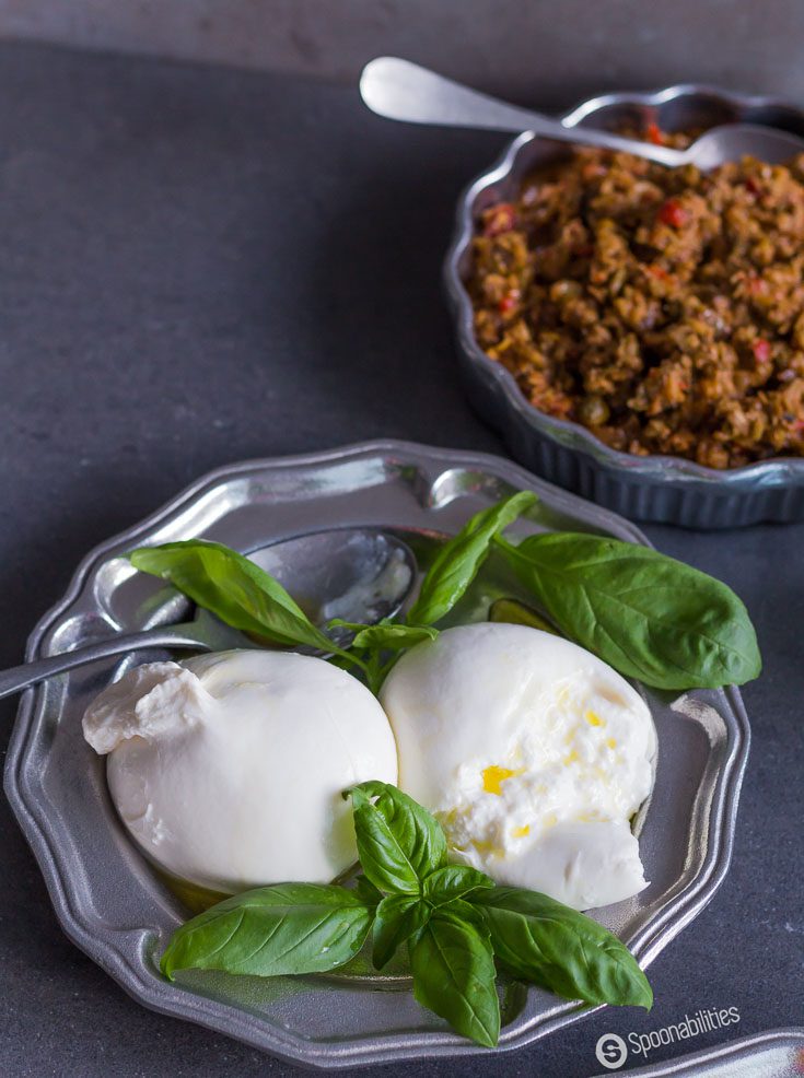 Fresh Stuffed Squash Blossoms are filled with burrata & Kalamata Olive & Oregano Spread, bringing a blend of Mediterranean flavors to your table. Spoonabilities.com