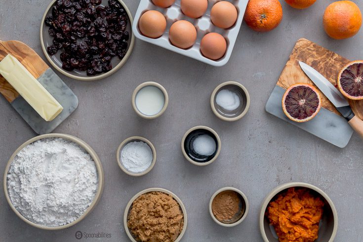 Table full of ingredients to make Cherry Pumpkin Scones like Blood Orange, Pumpkin, flour, dried cherries, buttermilk, brown sugar, butter, etc. Spoonabilities.com