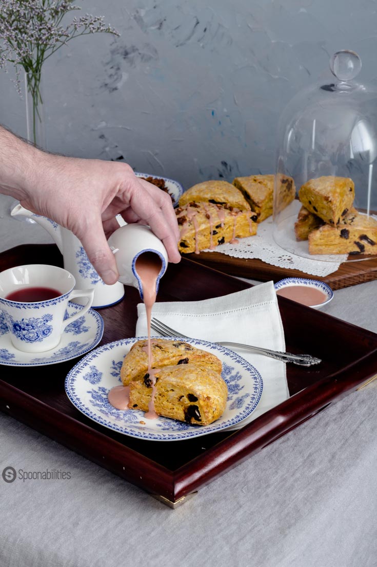 Moist, soft and crumbly Cherry Pumpkin Scones with a drizzle of blood orange & maple syrup glaze and garnished with roasted pumpkin seeds. Spoonabilities.com