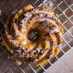 Mini Pumpkin Pecan Cakes is a combination of doughnuts and cake, all in one piece of heaven with orange glaze. Spoonabilities.com