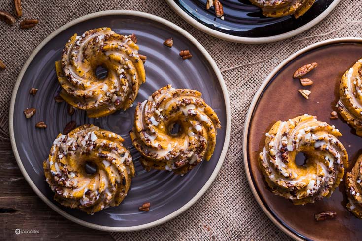 Mini Pumpkin Pecan Cakes are little bundt cakes perfect for breakfast and dessert. Made with chunks of toasted pecans and a citrusy Orange glaze. Spoonabilities.com