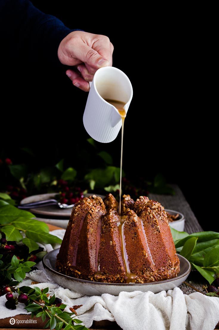 The drizzle for Pecan Pie Bundt Cake is made of brown sugar, butter, and cream. Greek Woodland Honey with Sage makes this cake extra moist. Spoonabilities.com