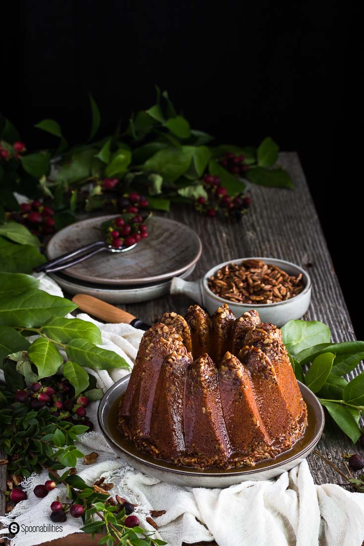 Pecan Pie Bundt Cake made with the Kugelhopf Bundt pan. Dramatic pecan crown top with brown sugar syrup dripping through the sexy curves. Spoonabilities.com