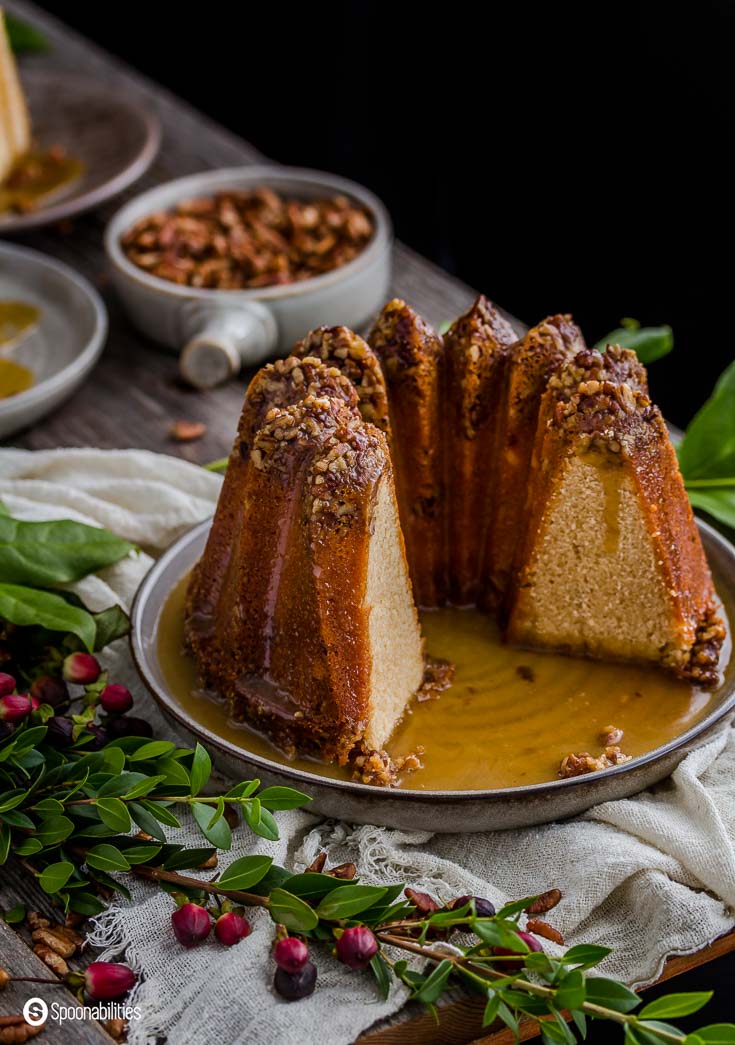 Pecan Pie Bundt Cake is luscious and rich dessert. The cake is so moist and delicious with a crown of decedent pecans lining the top of tall towers of a cake. Spoonabilities.com 