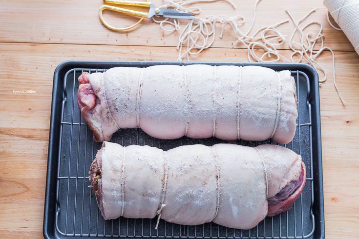 Pork Porchetta all rolled up. The secret for a pork porchetta with a crispy, golden and crackling skin is a mixture of salt and baking powder rubbed on the top before baking. Spoonabilities.com