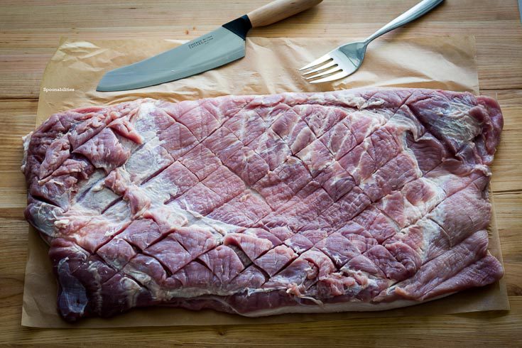 Pork Porchetta is an Italian recipe using pork belly. Here are the diamond shapes cut. Spoonabilities.com