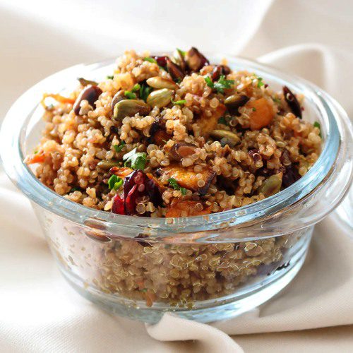 Quinoa Salad with Roasted Butternut Squash and Pumpkin Honey Mustard Vinaigrette in a glass bowl. This recipe is great as a side dish for all your meals, or for lunch, or a full main dinner dish. Spoonabilities.com