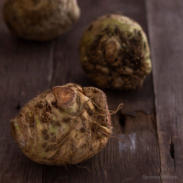 Three Raw Celery Root on a wooden board. Celery Root is low in cholesterol & saturated fat, and high in vitamins. Healthy soup recipe. Spoonabilities.com