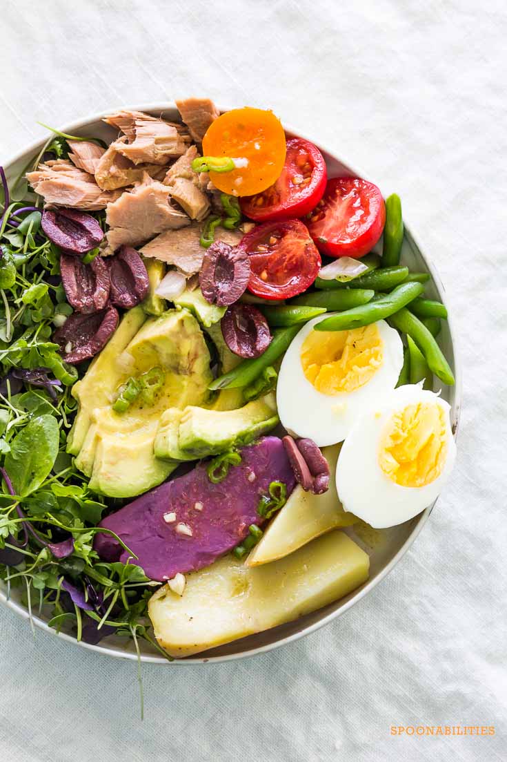 one large bowl of Classic Nicoise Salad on a gray linen tablecloth