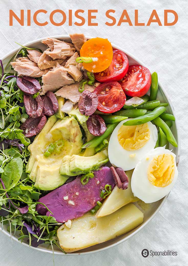 Dinner bowl of Classic Nicoise Salad with tuna, potatoes, green beans, eggs and microgreens