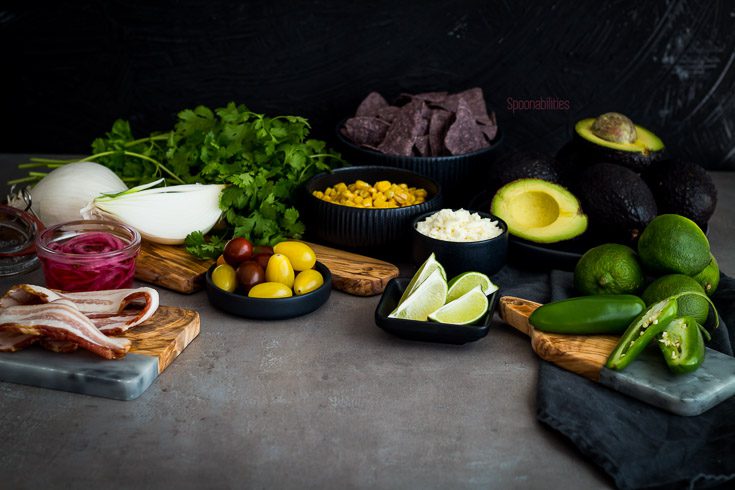 The best guacamole recipe with corn, bacon, cotija Cheese, lime, cilantro, jalapeño, coriander, cumin & salt. More Recipes for Cinco de mayo at Spoonabilities.com