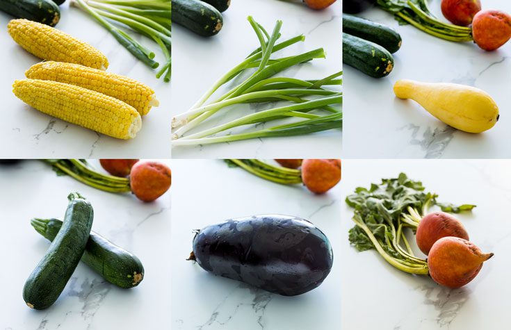 Whole vegetables in a counter top like corn, green onions, zucchini, yellow squash, yellow beets and eggplant. Spoonabilities.com