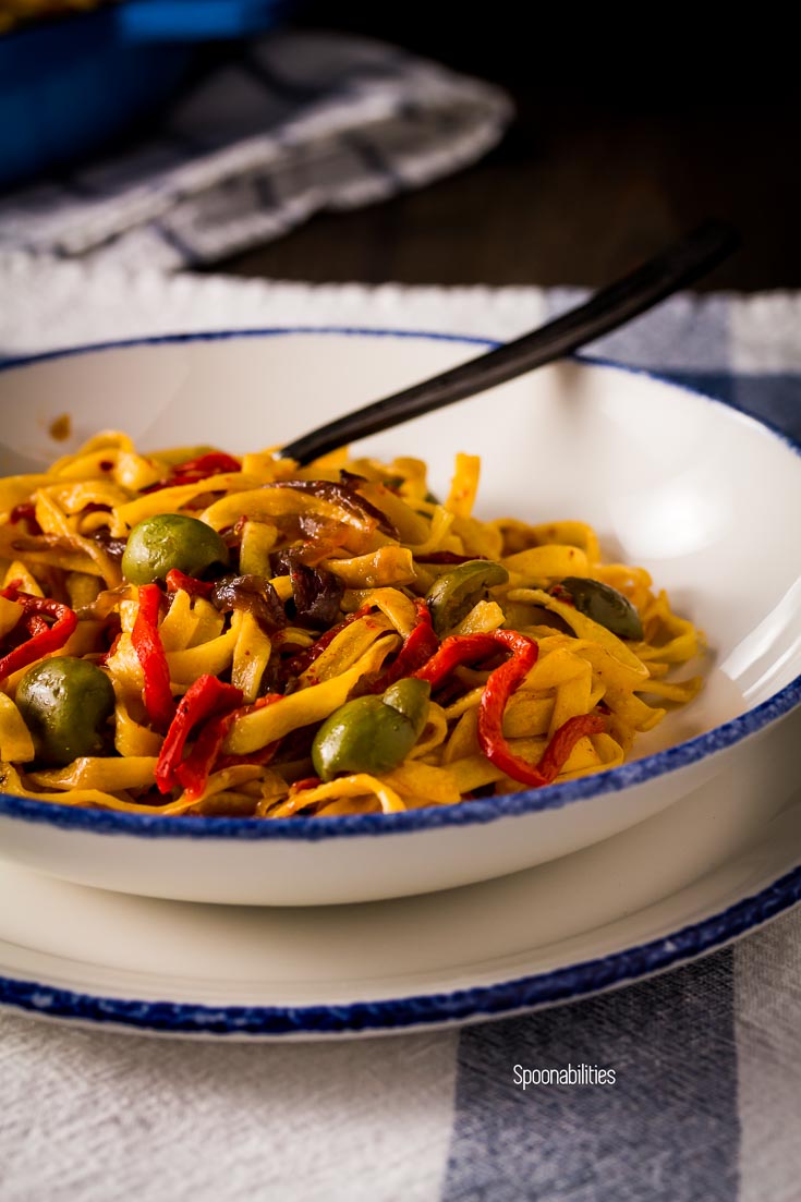 Close up of the roasted red pepper pasta in white plate with blue ring. Spoonabilities.com