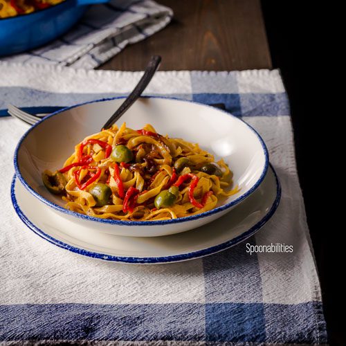 Roasted Red Pepper Pasta on a white plate with Sicilian Olives is a healthy, quick and easy pasta for any weeknight meal. Simple pasta recipe full of flavor. Spoonabilities.com