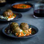 Easy lamb meatball recipe appetizer made with fresh herbs & spices. Served in a bed of Greek yogurt & a flavorful piquillo peppers pesto. Ready in 15 minutes. Spoonabilities.com