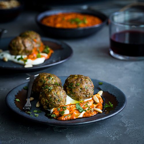 Easy lamb meatball recipe appetizer made with fresh herbs & spices. Served in a bed of Greek yogurt & a flavorful piquillo peppers pesto. Ready in 15 minutes. Spoonabilities.com