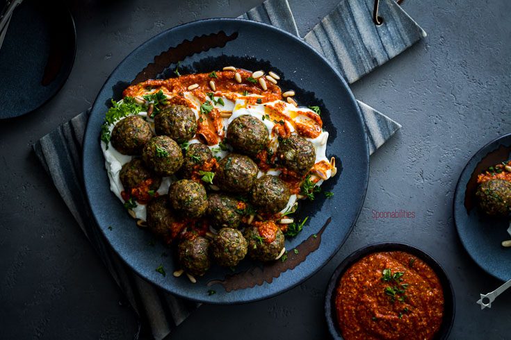 Large plate with Lamb meatballs are perfect as an appetizer or as a main dish. Served in a bed of Greek yogurt and a Piquillo pepper pesto. Spoonabilities.com