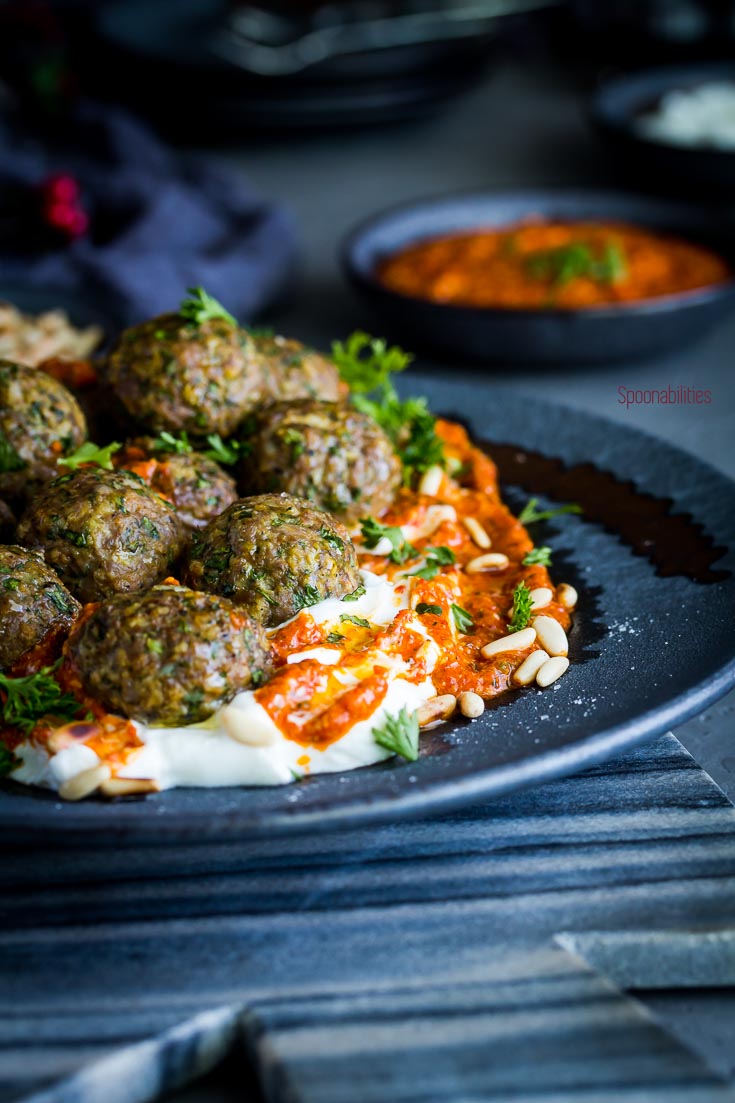 Close up shot of the large plate with spiced lamb meatballs with piquillo pepper pesto. Spoonabilities.com