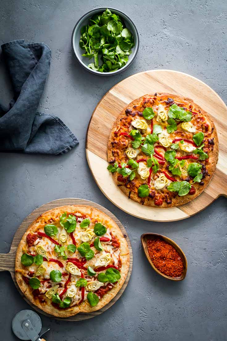 Crispy Cauliflower Crust Pizza has a delightful Italian flavor. Made with pizza sauce, baby artichokes and roasted red pepper. Garnished with watercress and cilantro leaves and dressed in a light lemony vinaigrette. Spoonabilities.com