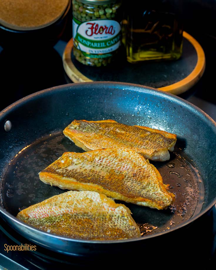 Crispy skin snapper in the fry pan in the stove. Spoonabilities.com